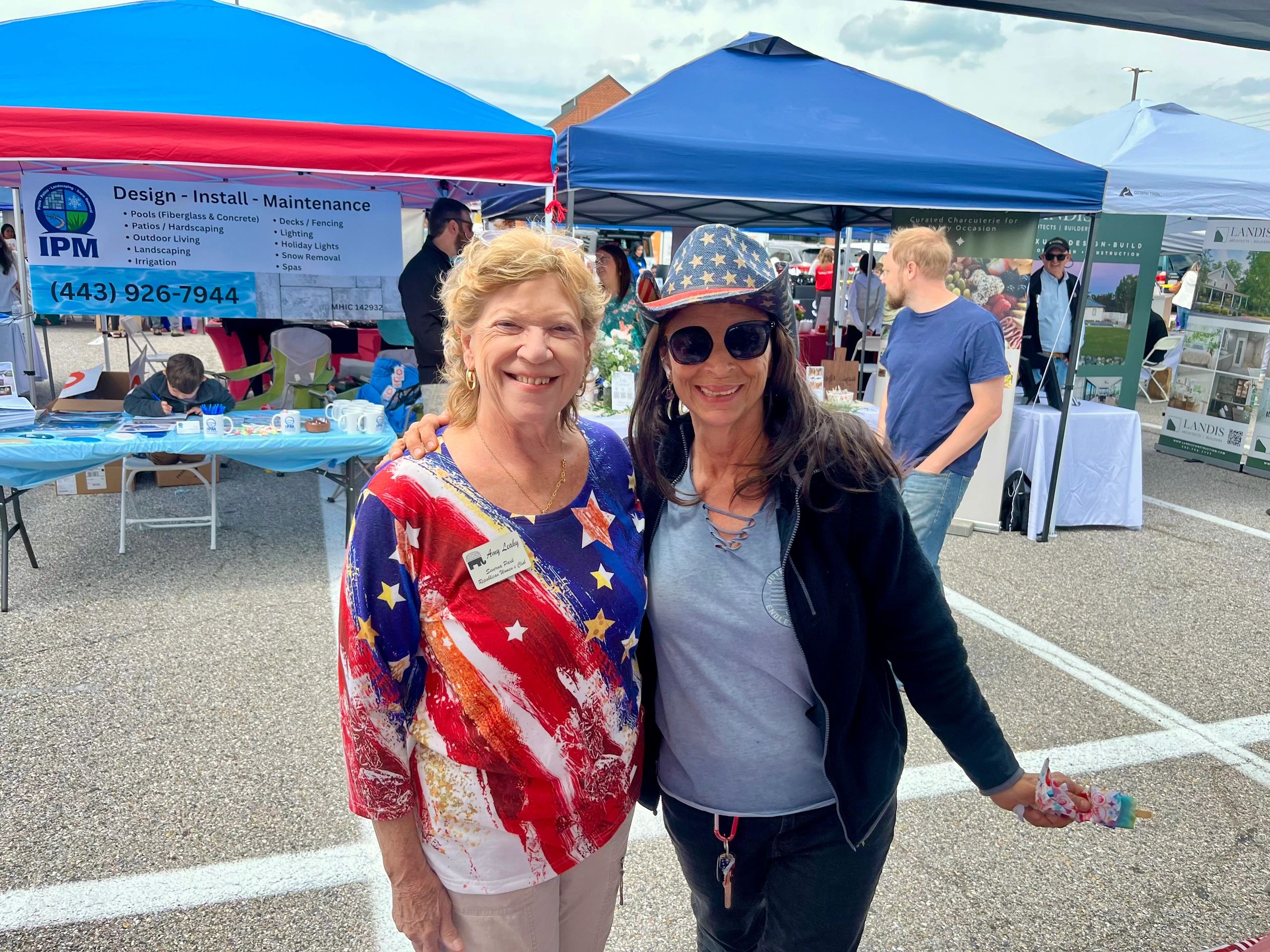 Amy at a local outdoor event with a neighbor